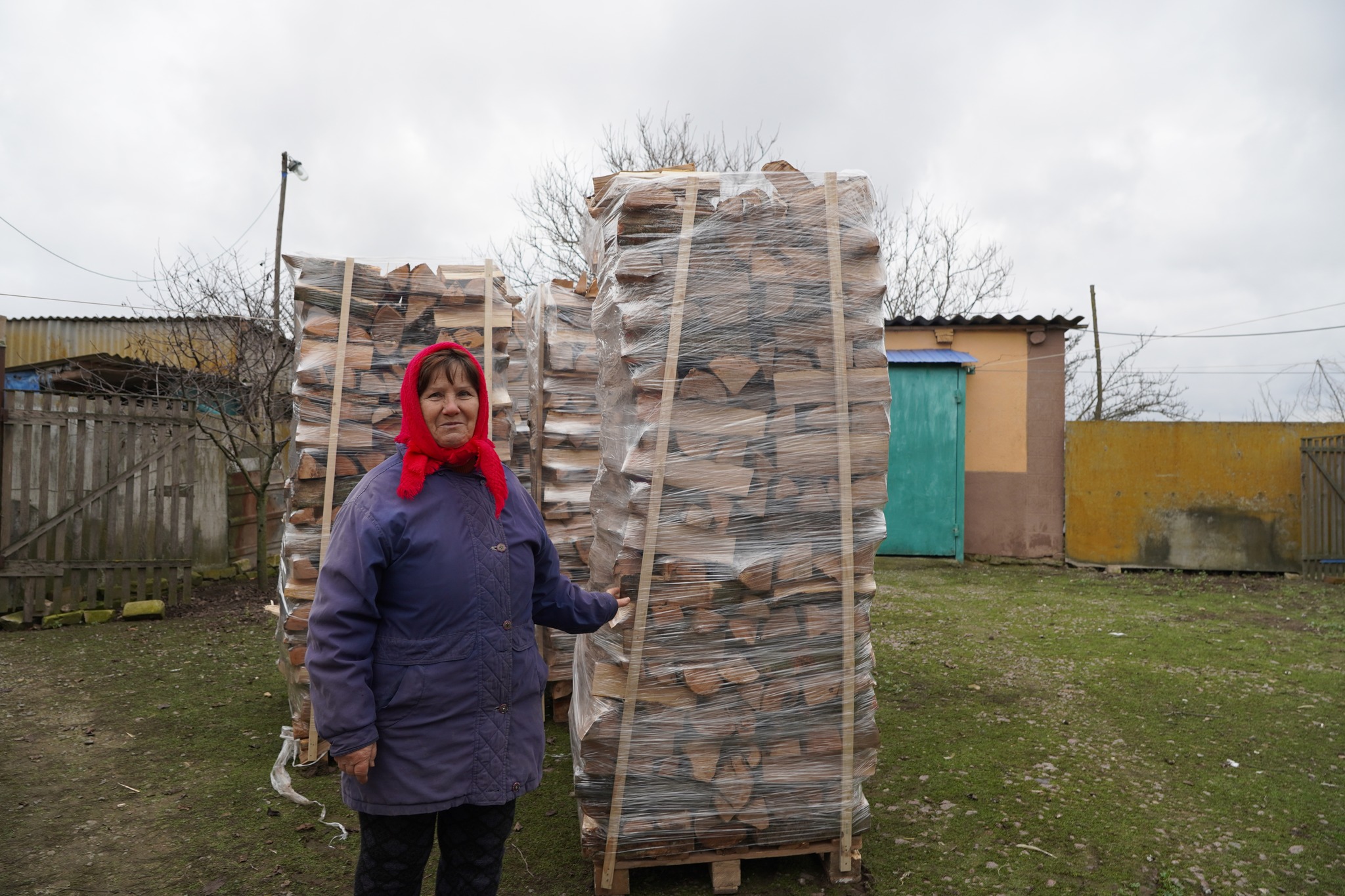 Woman standing with logs 