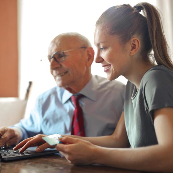 young woman old man computer