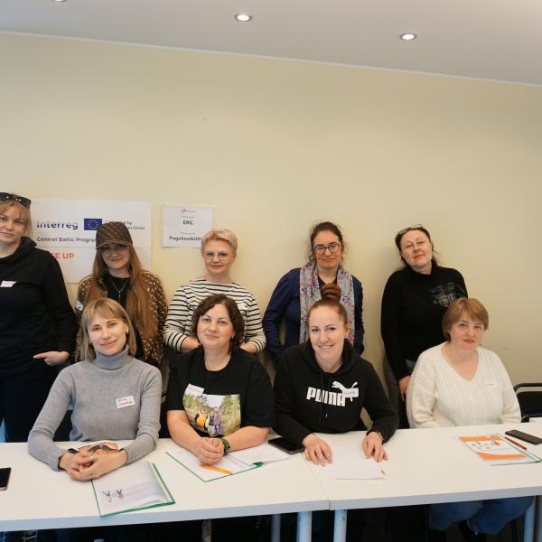 People posing behind a table 