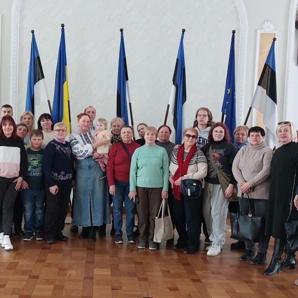 People standing infront of flags